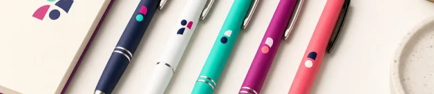 Promotional pens arranged with a small notebook